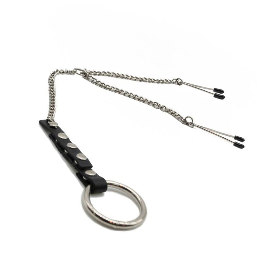 The Tweezer Clamps/Cock Ring Set is displayed against a blank background. The silver tweezer clamps are attached to a Y-shaped chain, which connects to a leather strap with a metal cock ring at the bottom.