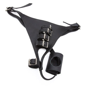 The black Leather Male Chastity Harness is displayed against a blank background. It resembles a thong with adjustable hip straps and four straps in the center. There is a removable leather dildo holder on the back strap.