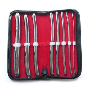 The 8 Piece Hegar Urethral Sounds kit is shown against a blank background. The case is book-shaped with a black exterior and red interior and is laid flat, displaying the sounds. The sounds are made of metal and increase in size from right to left.