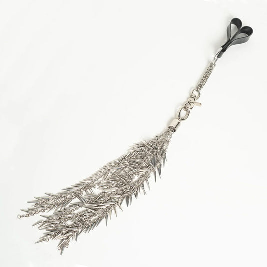 Silver metal feather-shaped flogger on a white background