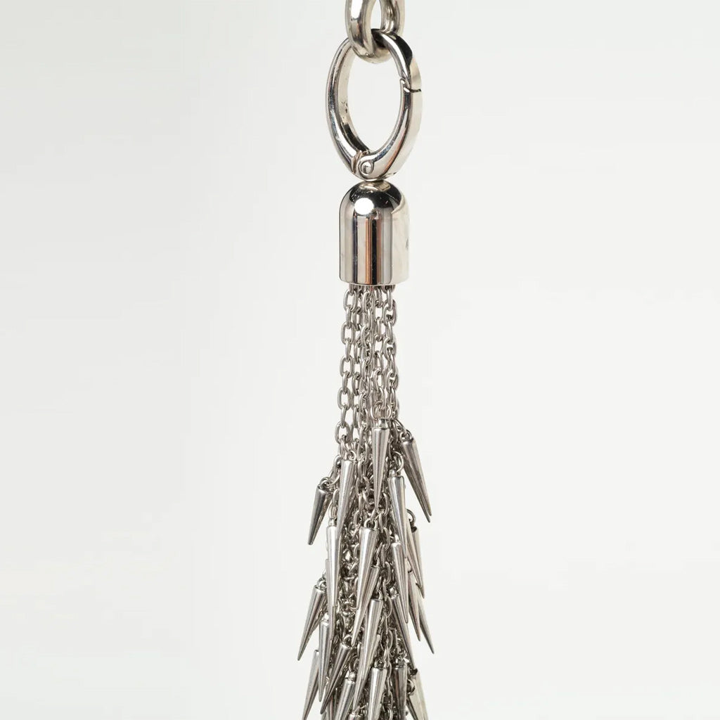 close up of attachment for silver flogger on a white background