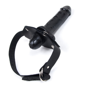 The black In And Out Penis Gag With A Removable Dildo is displayed against a blank background. Only the head of the dildo is pushed through to the interior of the gag, with most of the dildo on the outside.