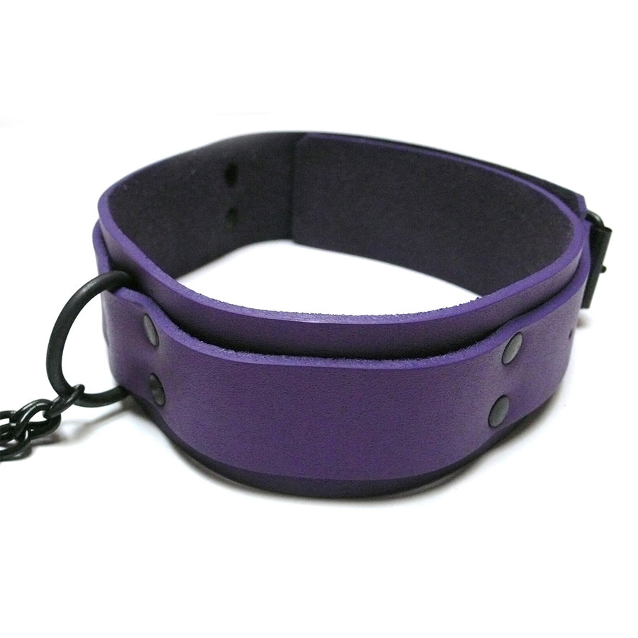 The purple leather Buckling Collar With Nipple Clamps is displayed against a blank background. It has black hardware, including a D-ring in the front.