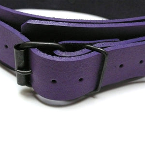 A close-up of the purple leather Buckling Collar With Nipple Clamps is displayed against a blank background, showing the adjustable strap of the collar.