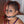 Load image into Gallery viewer, A close-up of a woman with half of her head shaved is shown. She wears a black ball gag and the Steel Nose Hook attached to a rawhide lace, which pulls up her nostrils.
