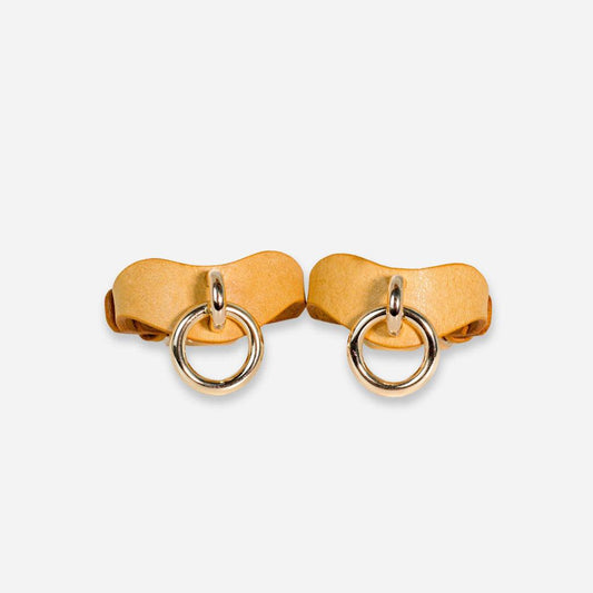 Two BDSM wrist cuffs made of bright yellow leather from a front view. In the center is a silver nickel-plated attachment point.