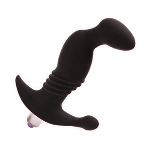 The matte black silicone Tantus Prostate Play Massager is shown against a blank background. It is shaped like an average plug, but it has a noticeable sideways protrusion at the top. The base is flared and with a silver bullet vibrator inserted into it.