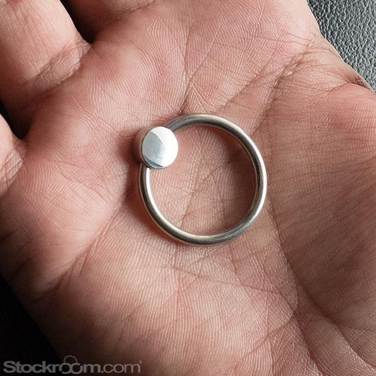 A close-up of a hand is shown holding the head ring with pressure bead,