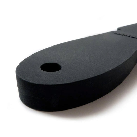 A close-up of the handle of the Wham Bam Tantus Paddle is displayed against a blank background. The handle has a small hole at the base.