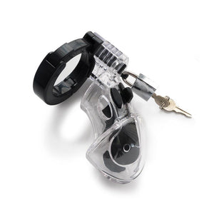 The Mystim Pubic Enemy No. 1 Male Chastity Device is displayed against a blank background. It is a clear plastic cage shaped like a penis with black silicone lining. There is a small silver lock at the top with a brass key hanging out.