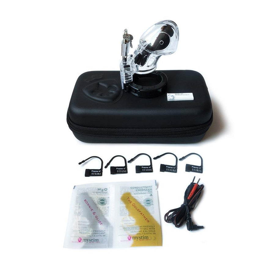 The case for The Mystim Pubic Enemy No. 1 Male Chastity Device is displayed against a blank background with all the contents displayed, including the cage, wires, five black plastic locks, and lube and conductivity gel packets.