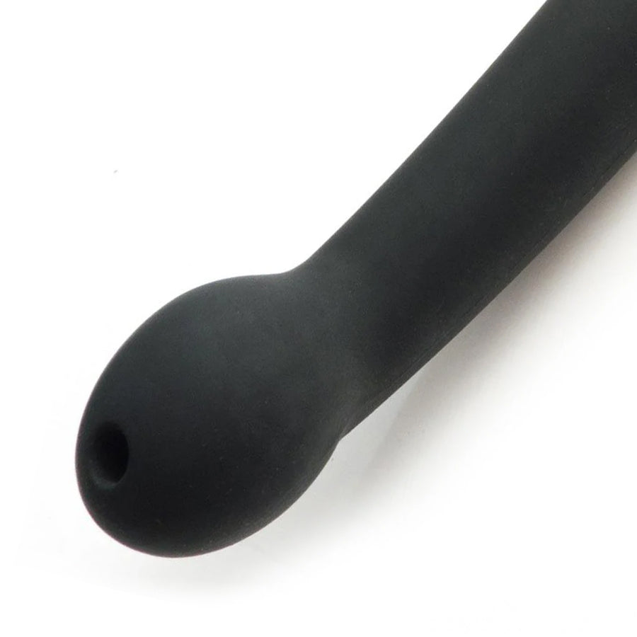 A close-up of the bottom of the handle of the Tantus Plunge Paddle is shown against a blank background. The handle has a curved, bulbous end, which has a small hole at the top. 