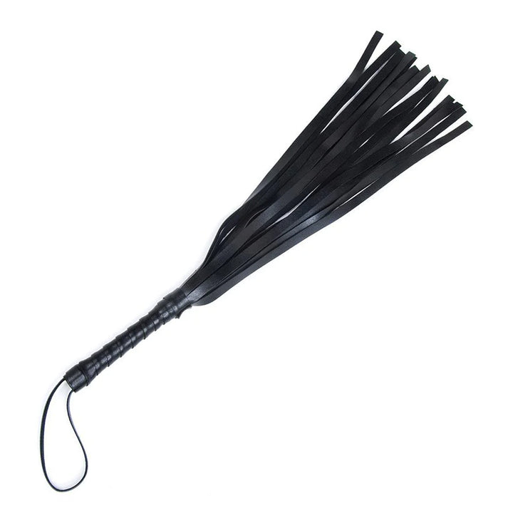 The black vinyl S&M Mini Flogger from Sportsheets is displayed against a blank background. The flogger has thin black falls, a wrapped handle, and a small loop at the base of the handle.