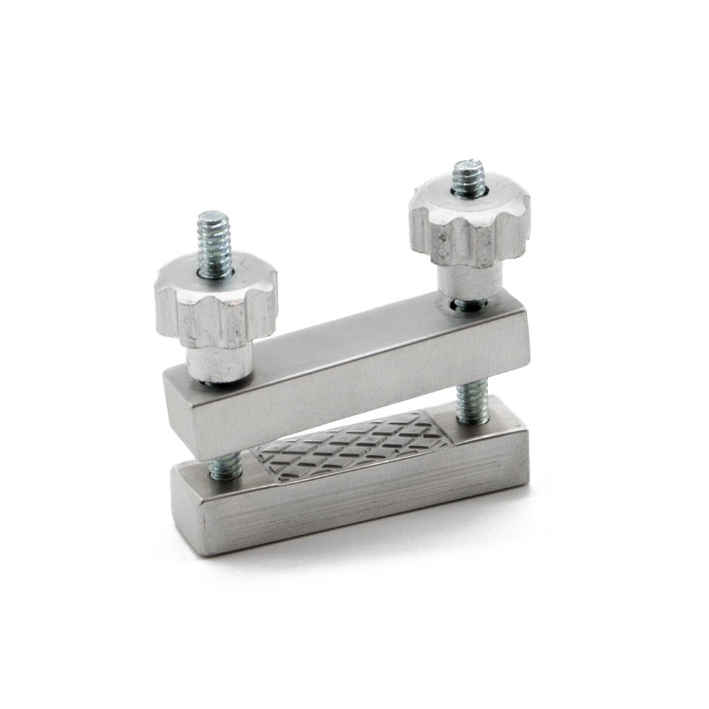 One Extreme Adjustable Nipple Clamps is shown assembled against a blank background. Two aluminum jaws are on top of each other with a little space between them. They are supported by a bolt and nut on each side.