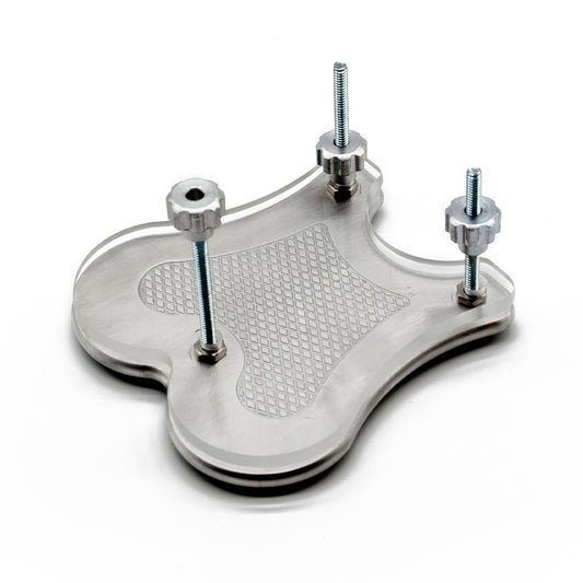 The Extreme CBT Ball Crusher is shown assembled with the metal and acrylic plates on top of each other and the nuts partially screwed onto the bolts.
