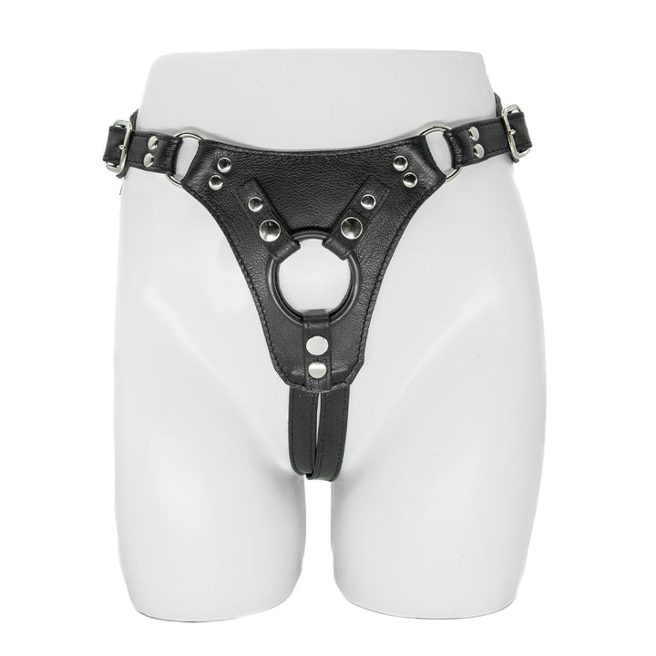 The Minx Licorice Leather Strapon Harness is displayed on the lower half of a mannequin against a blank background. The harness is made of black leather and has silver rivits on the seams.