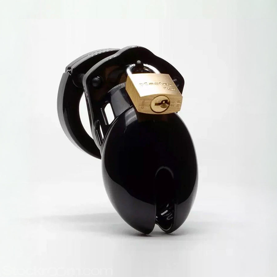 The CB-6000S Male Chastity Device in black is shown from the front against a blank background. A small, rectangular slit at the tip of the cage is visible.