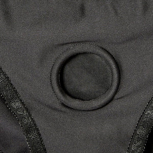 A closeup of the Em.Ex. Silhouette Crotchless Strapon Harness, showing the fabric-covered O-Ring.