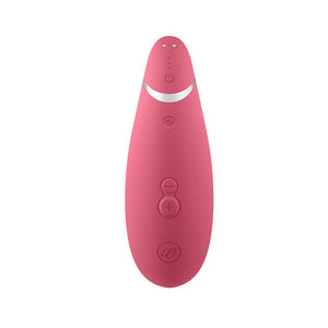 The Raspberry Womanizer Premium 2 is shown from the back against a blank background. Its three buttons and magnetic charging ports are visible.