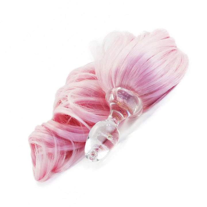 The Pink Detachable Ponytail Glass Butt Plug is shown against a blank background. The plug is made of clear glass and has a long, light pink tail attached to the base. 