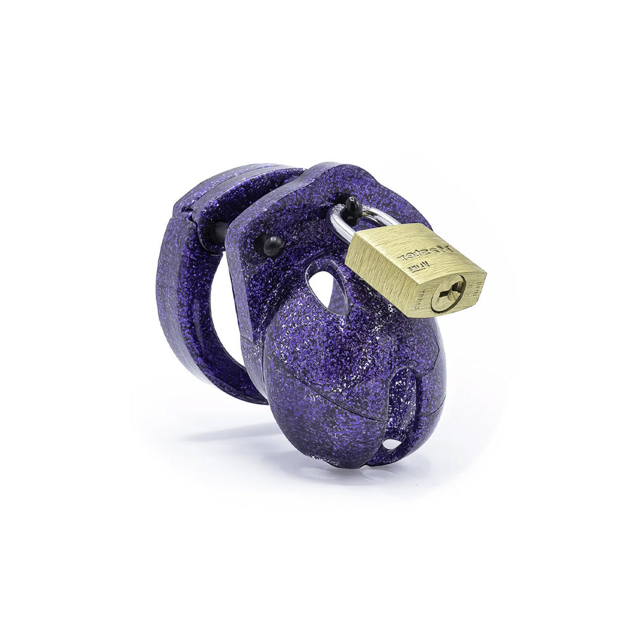 The CBX "Mini-Me" penis cage, shown on a white background. The cage is made of purple plastic with a glittery surface. A brass padlock holds the top closed. 