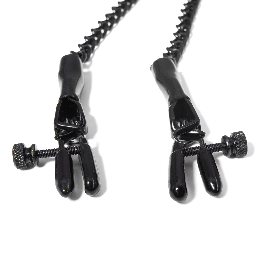 The black spring jaw nipple clamps are shown laying against a white background