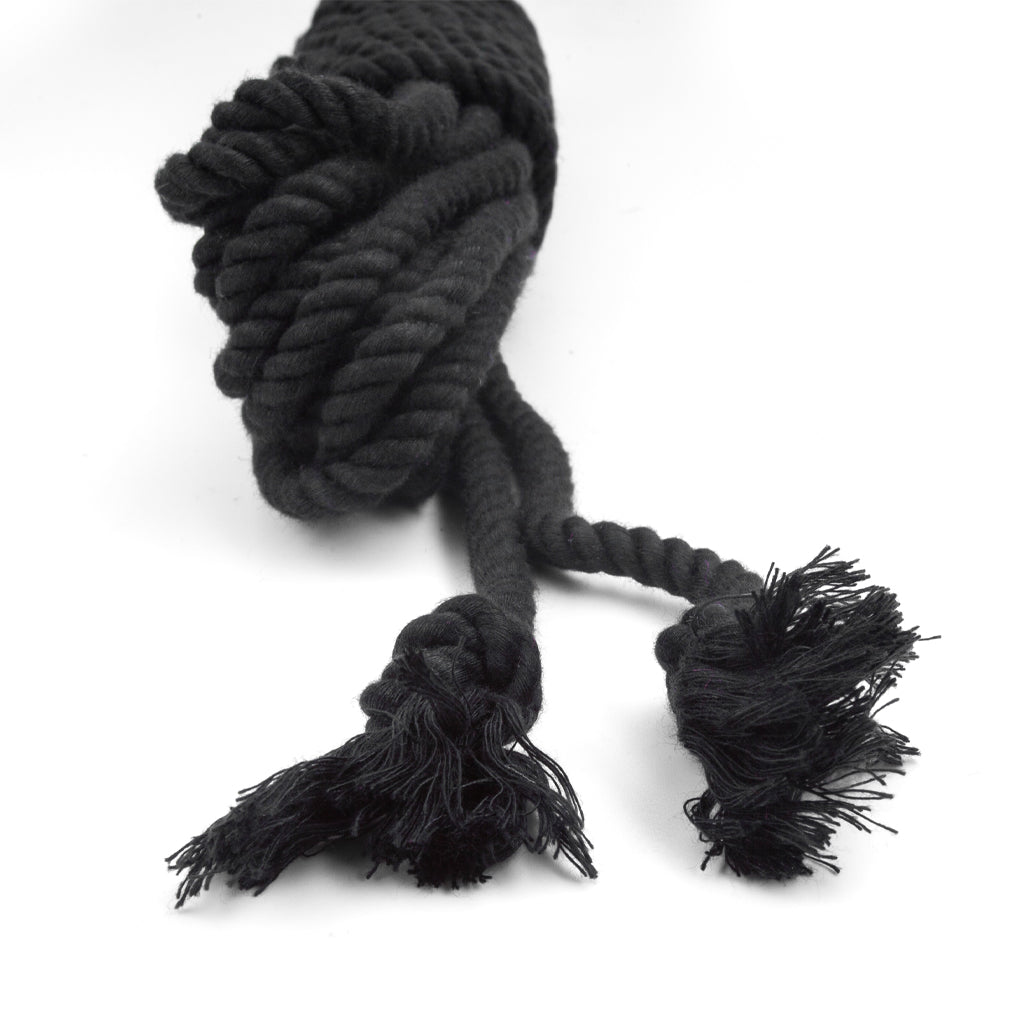 The knotted ends of the black bamboo silk rope is shown on a white background.