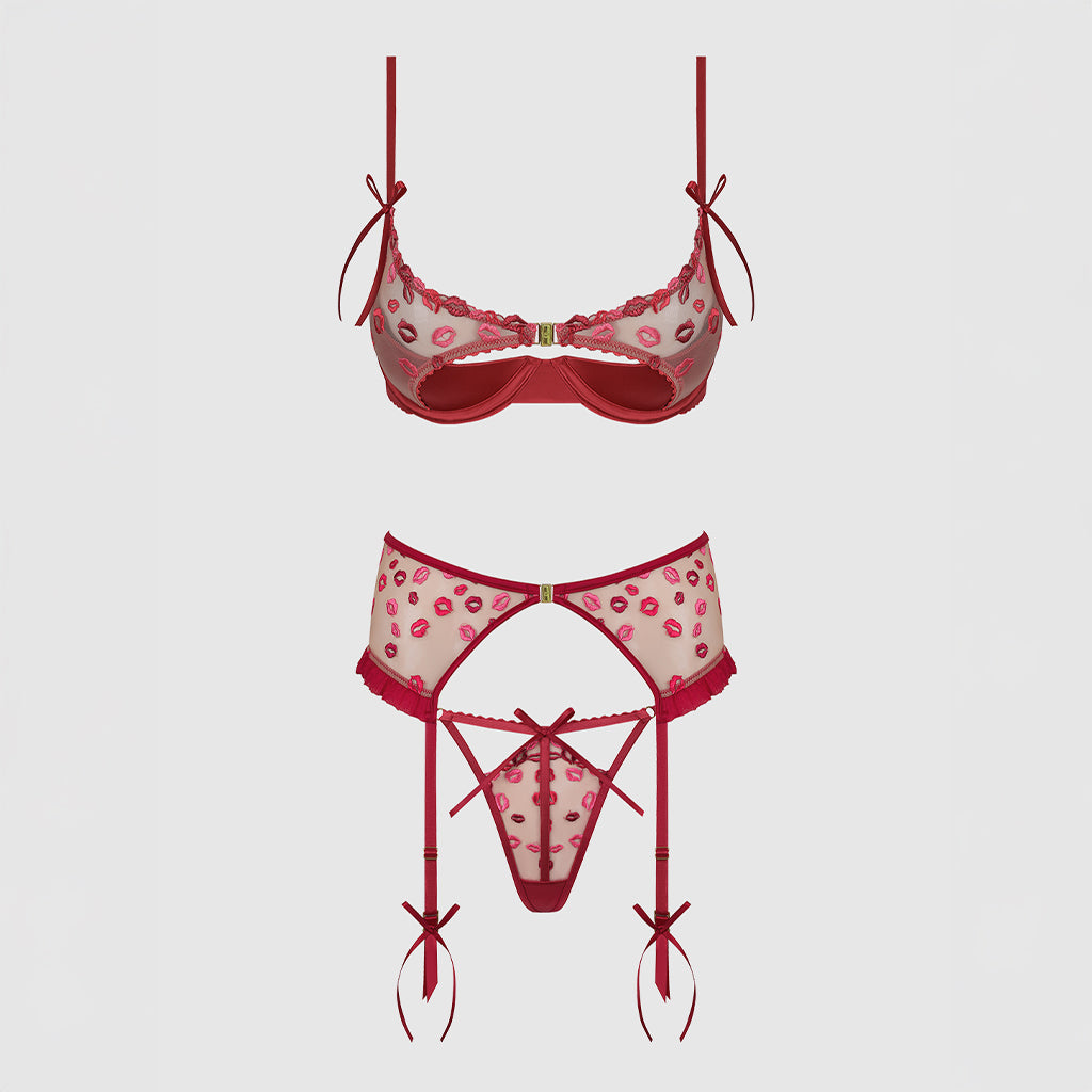 Red and pink patterned lingerie set on a light gray background