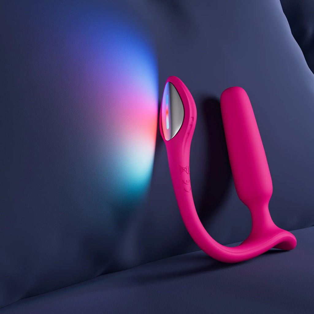 The Lovense Lush anal dual vibrator is shown on a purple bed