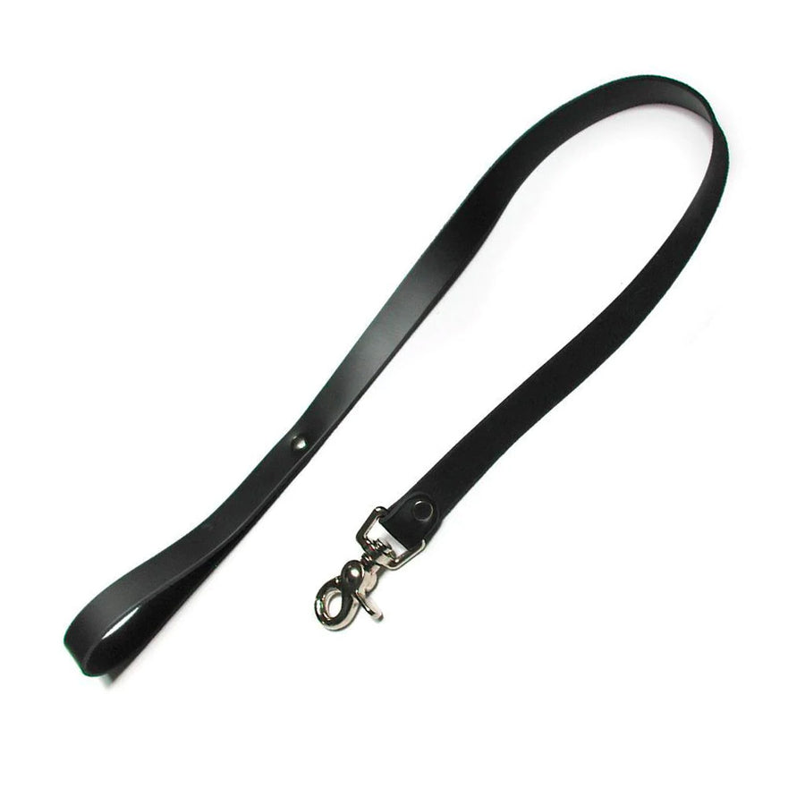 The black leather leash is shown against a blank background. It is made of a thin strip of black leather with a wrist loop at one end and a metal snap hook on the other.
