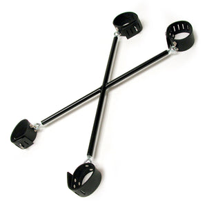 The X-Bars Spreader is displayed against a blank background. It is a spreader bar in the shape of an X. At each point, there is a black leather locking cuff.