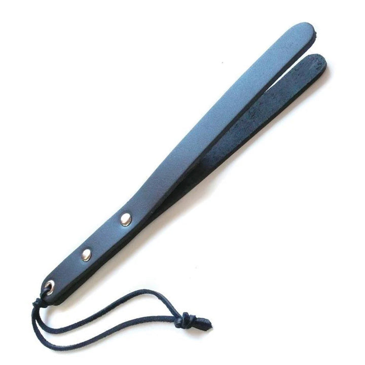 The black leather Mini-Slapper is shown against a blank background. It is shaped like a thin, curved rectangle, made of two pieces of leather connected at the base and split apart from middle to tip. There is a wrist loop at the base of the handle.