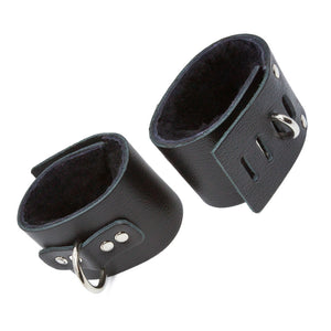 The black leather Fleece-Lined Ankle Cuffs with a D-Ring are displayed against a blank background.