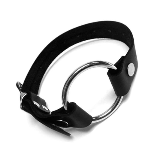 The Leather Thigh Dildo Strap is displayed against a blank background. The harness is made of a strip of black leather with a large silver O-ring in the center. The strap is adjustable and has a metal buckle closure.