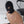 Load image into Gallery viewer, A person with hazel eyes stands in front of a white wall, wearing the Spandex Hood With Open Mouth And Eyes. The hood is made of black spandex fabric and completely covers their face, head, and neck, with openings for the eyes and mouth.
