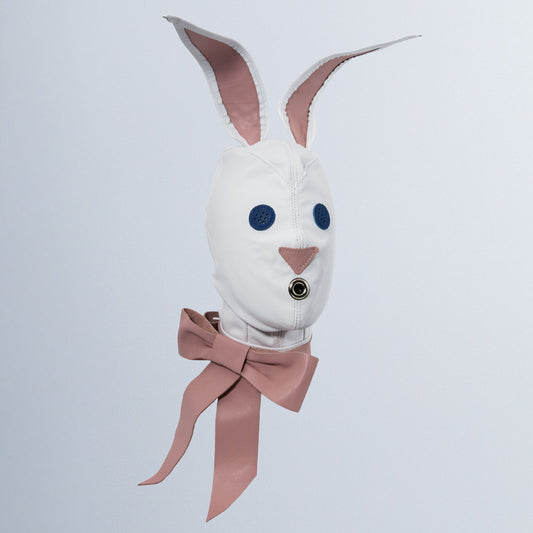 The white Leather Bunny Hood is displayed against a blank background. The small mouth opening is a metal circle. The bunny ears are lined with pink leather on the inside. One ear stands up straight and the other folds over.