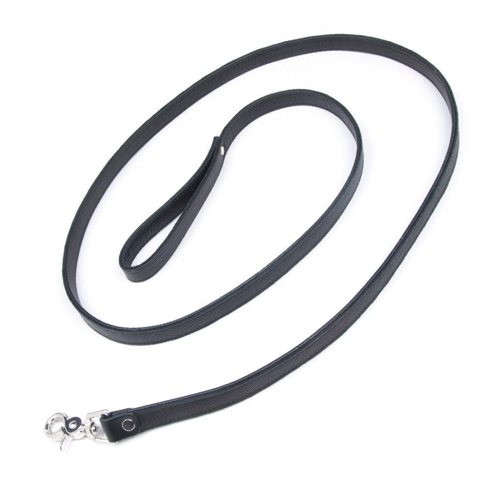 The black Leather Leash is shown against a blank background. It is a thin strip of black leather with a wrist loop on one end and a snap hook on the other.