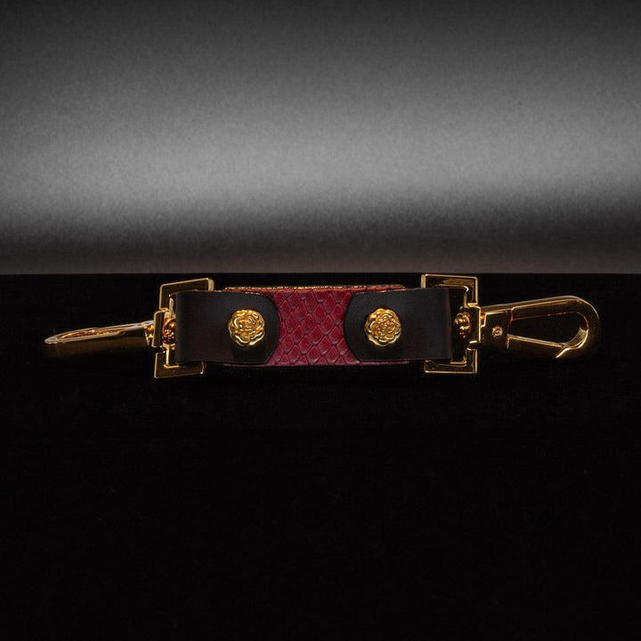 The Melanie Rose Designs x The Stockroom Restraint Clip is displayed against a black background. 