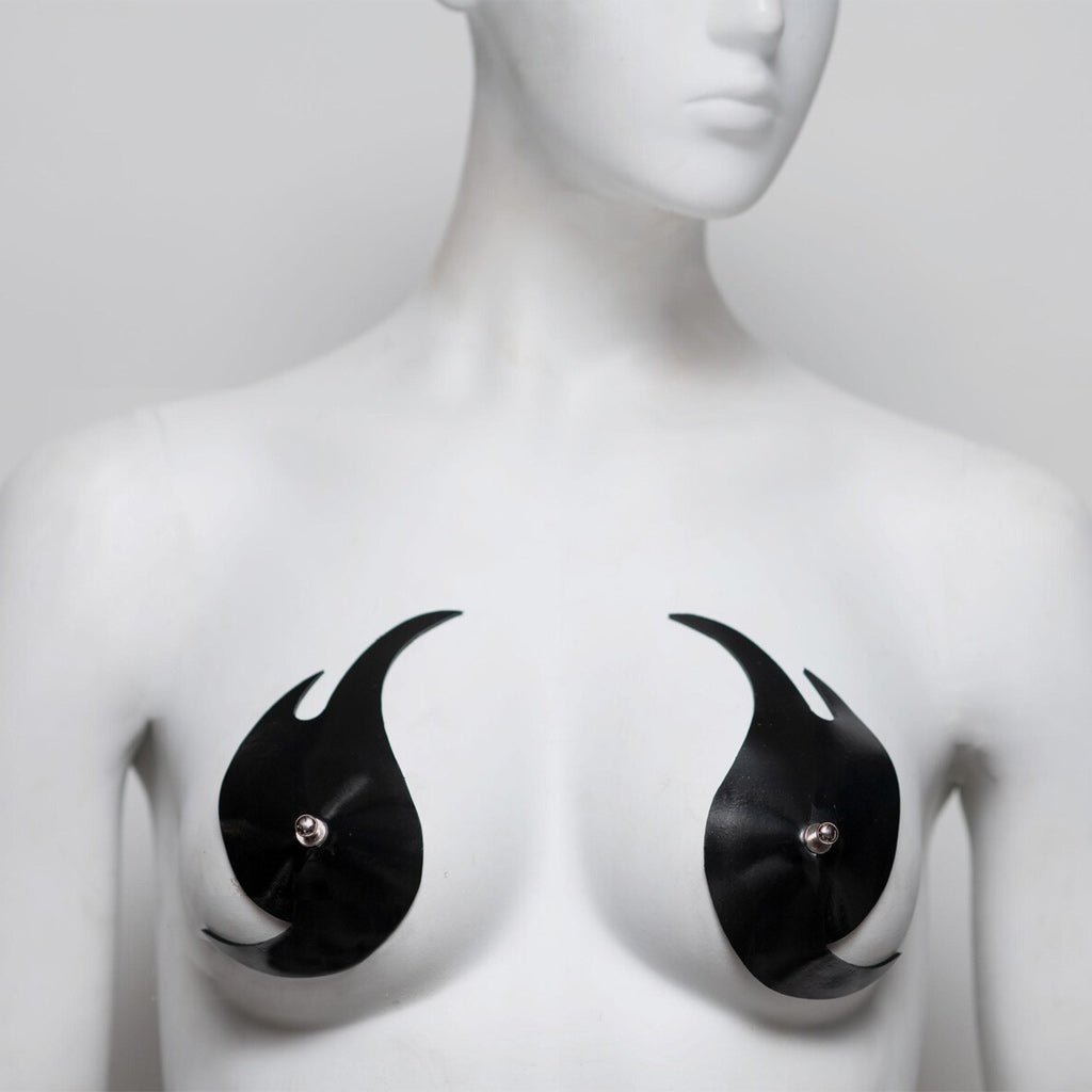 Black flame-shaped pasties on a mannequin bust against a white background