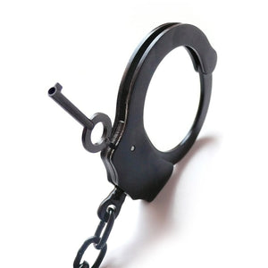 A close-up of one of the cuffs of the black Kinklab Double-Lock Police-Style Handcuffs is shown against a blank background.