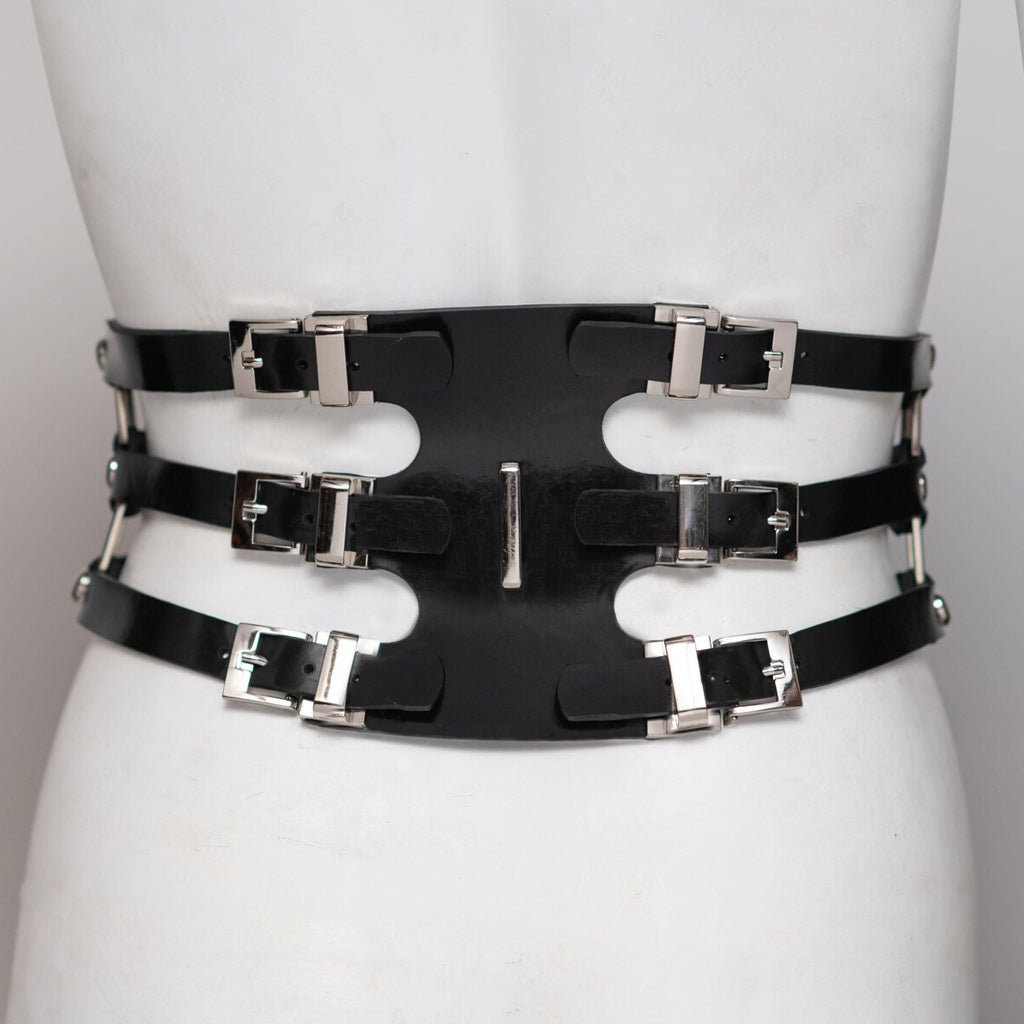 Black rubber belt with silver buckles on a mannequin against a white background