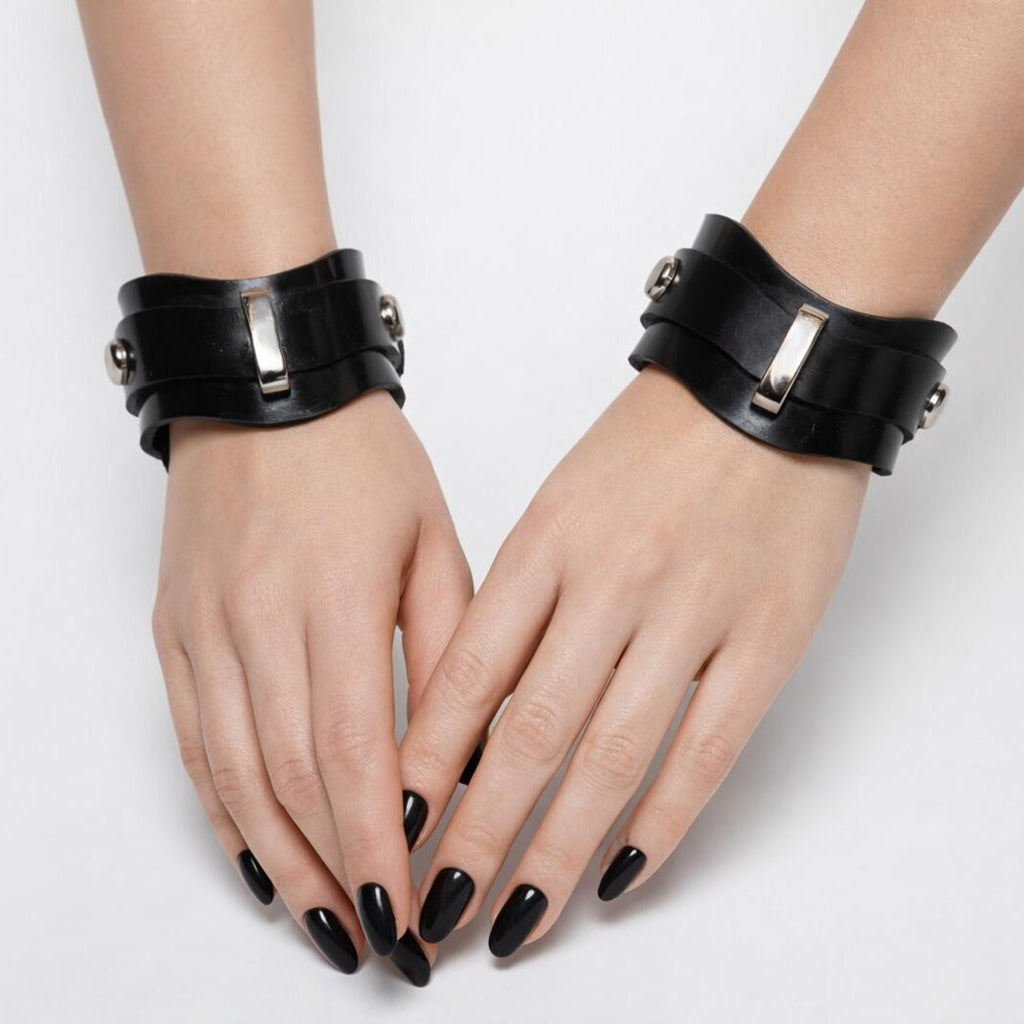 A womans hands are shown wearing the novella shaped cuffs on a white background. 
