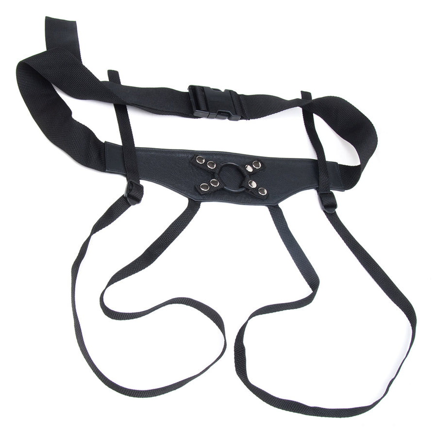 The black leather Crown Strap-on harness is displayed against a blank background. The harness has a leather front piece attached to a black nylon waist strap with a plastic buckle. The leg straps are made of thinner strips of nylon.