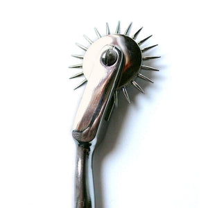 A closeup of the Wartenberg Pinwheel’s wheel is shown against a blank background.