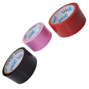 Three roles of Unpackaged Bondage Tape, one of each color, are displayed against a blank background. The roll of tape on the left is red, the one in the middle is black, and the one on the right is pink.