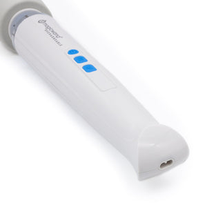 The end of the handle of the Magic Wand Rechargeable is shown against a blank background, showing its charging port, with the charger positioned behind it.