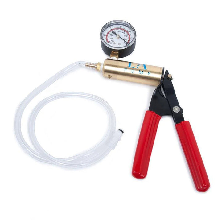 The brass Deluxe Hand Pump is shown against a blank background. The handle is made of two red cylinders that can be squeezed to create pressure. They are attached to a brass cylinder with a pressure gauge, which is attached to a long plastic tube.