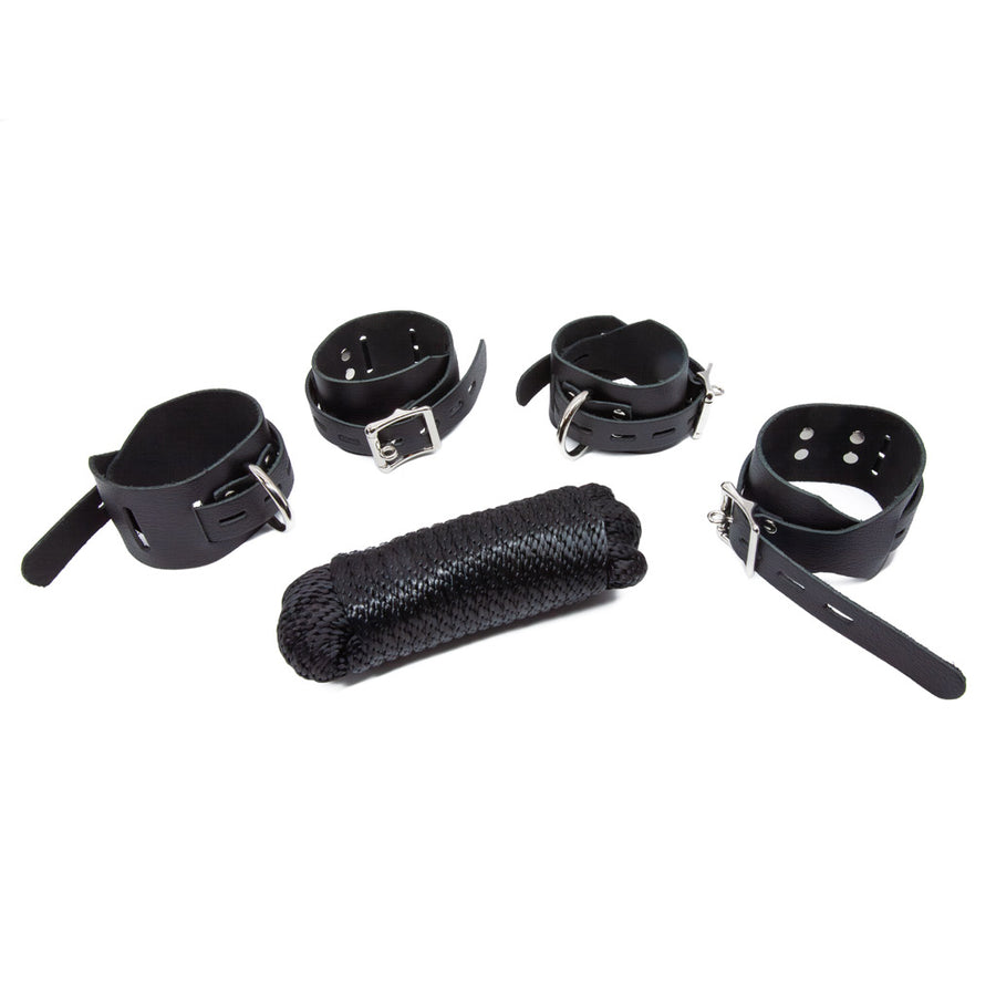 Some of the contents of the Bondage 101 Kit made by The Stockroom are shown on a white background. Shown in this image are the two pairs of black leather locking buckling bondage restraints and black nylon rope.