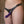 Load image into Gallery viewer, A nude woman is shown wearing the La Butch™ Strapon Harness. The harness is made of black leather with silver zipper lining on the front piece. It has silver buckles on the hips and a silver O-ring. A purple dildo is attached to it.
