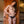 Load image into Gallery viewer, A nude woman with brown hair is shown standing against a wooden door and wearing the La Femme Strapon Harness with a realistic dildo attached. Her head is tilted and her hands are on her hips.
